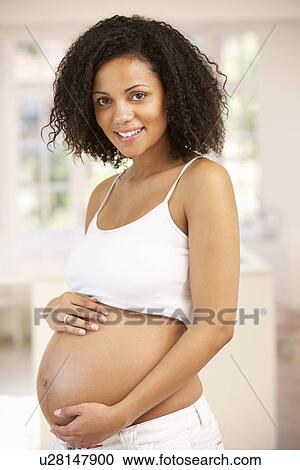 Pregnant woman at home View Large Photo Image Stock Image - Pregnant woman at home. Fotosearch