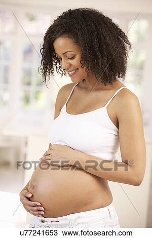 Pregnant woman at home View Large Photo Image Stock Image - Pregnant woman at home. Fotosearch