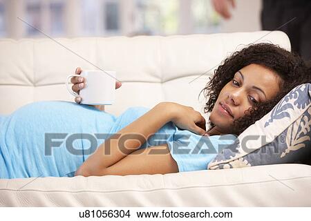 Picture - Pregnant woman resting at home. Fotosearch