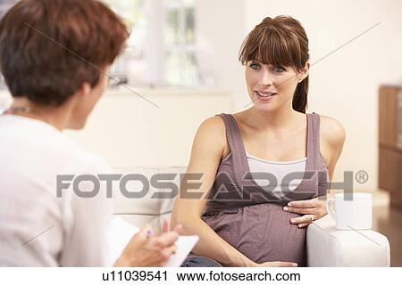Pregnant woman talking to midwife View Large Photo Image Stock Image - Pregnant woman talking to midwife. Fotosearch