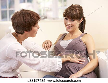 Pregnant woman talking to midwife View Large Photo Image Stock Photography - Pregnant woman talking to midwife. Fotosearch