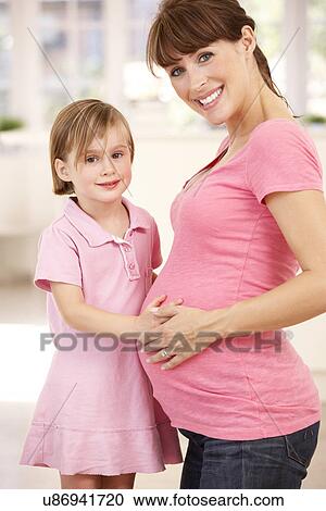 Pregnant woman with daughter View Large Photo Image Stock Image - Pregnant woman with daughter. Fotosearch
