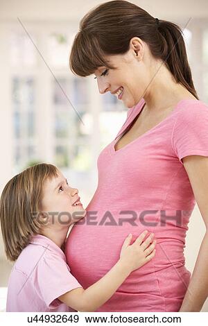 Stock Photo - Pregnant woman with daughter. Fotosearch