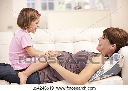 Pregnant woman with daughter View Large Photo Image Stock Photo - Pregnant woman with daughter. Fotosearch