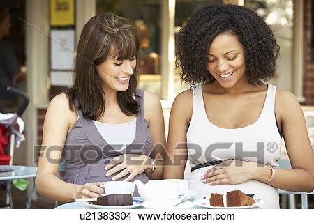 Pregnant women sitting outside café View Large Photo Image Picture - Pregnant women sitting outside café. Fotosearch
