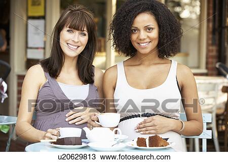 Pregnant women sitting outside café View Large Photo Image Stock Image - Pregnant women sitting outside café. Fotosearch