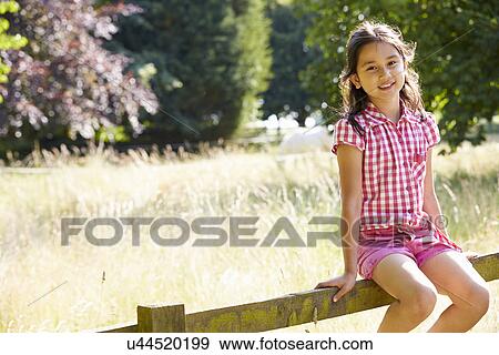 Pretty Asian Girl Sitting On Fence In Countryside View Large Photo Image Stock Photo - Pretty Asian Girl Sitting On Fence In Countryside. Fotosearch