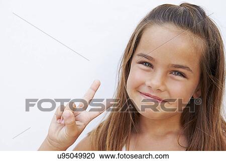 Pretty Hispanic Girl Standing By Wall Making Peace Sign View Large Photo Image Stock Image - Pretty Hispanic Girl Standing By Wall Making Peace Sign. Fotosearch