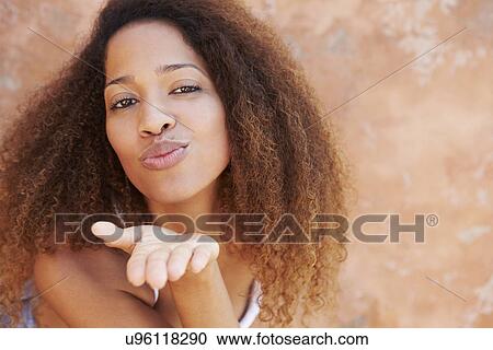 Pretty Young Woman Blowing Kiss Towards Camera View Large Photo Image Stock Image - Pretty Young Woman Blowing Kiss Towards Camera. Fotosearch