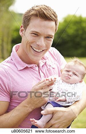 Proud Father Holding Baby Daughter In Garden View Large Photo Image Stock Image - Proud Father Holding Baby Daughter In Garden. Fotosearch