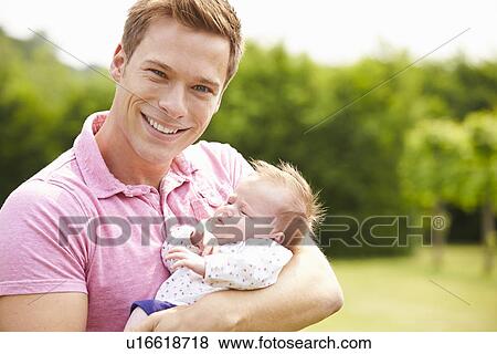 Proud Father Holding Baby Daughter In Garden View Large Photo Image Stock Photo - Proud Father Holding Baby Daughter In Garden. Fotosearch