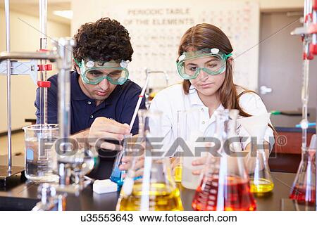 Pupils Carrying Out Experiment In Science Class View Large Photo Image Stock Image - Pupils Carrying Out Experiment In Science Class. Fotosearch