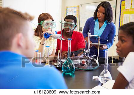 Stock Photo - Pupils Carrying Out Experiment In Science Class. Fotosearch