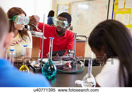 Pupils Carrying Out Experiment In Science Class View Large Photo Image Stock Photography - Pupils Carrying Out Experiment In Science Class. Fotosearch