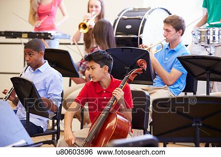 Stock Photograph - Pupils Playing Musical Instruments In School Orchestra. Fotosearch