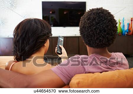 Rear View Of Couple Sitting On Sofa Watching TV Together View Large Photo Image Stock Image - Rear View Of Couple Sitting On Sofa Watching TV Together. Fotosearch