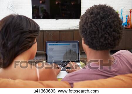 Rear View Of Couple Using Online Banking On Laptop View Large Photo Image Stock Image - Rear View Of Couple Using Online Banking On Laptop. Fotosearch
