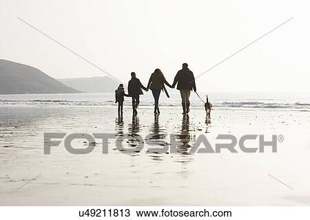Rear View Of Family Walking Along Winter Beach With Dog View Large Photo Image Stock Image - Rear View Of Family Walking Along Winter Beach With Dog. Fotosearch