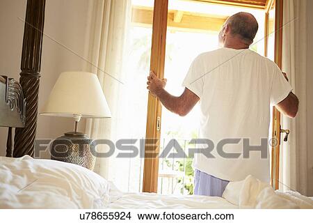 Rear View Of Man Waking Up In Bed In Morning View Large Photo Image Picture - Rear View Of Man Waking Up In Bed In Morning. Fotosearch