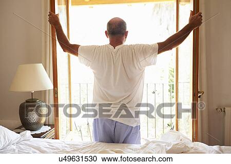 Rear View Of Man Waking Up In Bed In Morning View Large Photo Image Stock Image - Rear View Of Man Waking Up In Bed In Morning. Fotosearch