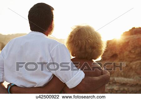 Rear View Of Senior Couple Watching Sunset Over Port View Large Photo Image Stock Image - Rear View Of Senior Couple Watching Sunset Over Port. Fotosearch