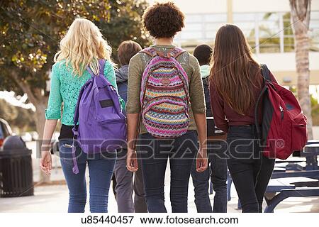 Stock Photo - Rear View Of Students Walking To High School. Fotosearch