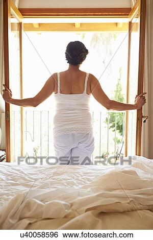 Rear View Of Woman Waking Up In Bed In Morning View Large Photo Image Stock Photograph - Rear View Of Woman Waking Up In Bed In Morning. Fotosearch