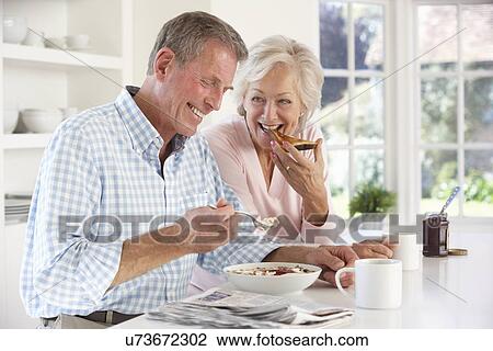 Retired couple eating breakfast View Large Photo Image Stock Image - Retired couple eating breakfast. Fotosearch