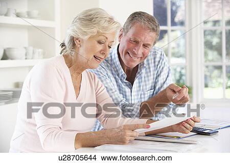Retired couple with household bills View Large Photo Image Picture - Retired couple with household bills. Fotosearch