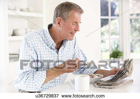 Retired man eating breakfast View Large Photo Image Stock Photo - Retired man eating breakfast. Fotosearch