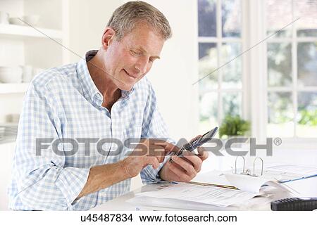 Retired man with household bills View Large Photo Image Picture - Retired man with household bills. Fotosearch