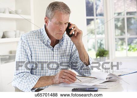 Retired man with household bills View Large Photo Image Stock Photo - Retired man with household bills. Fotosearch