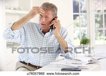 Retired man with household bills View Large Photo Image Stock Photograph - Retired man with household bills. Fotosearch