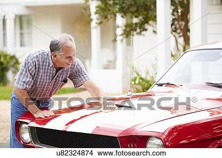 Picture - Retired Senior Man Cleaning Restored Car. Fotosearch