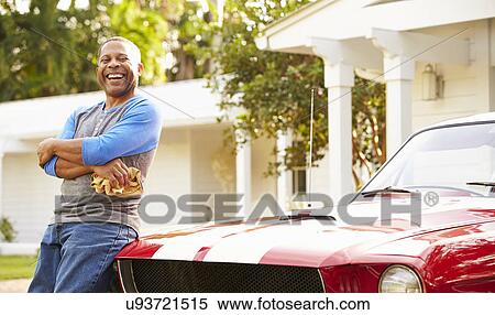 Stock Photography - Retired Senior Man Cleaning Restored Car. Fotosearch