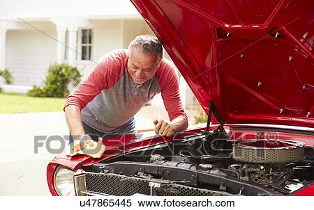 Stock Photography - Retired Senior Man Cleaning Restored Classic Car. Fotosearch