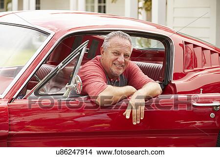 Picture - Retired Senior Man Sitting In Restored Classic Car. Fotosearch