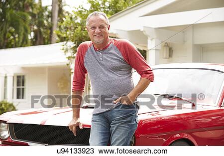 Stock Image - Retired Senior Man Standing Next To Restored Classic Car. Fotosearch