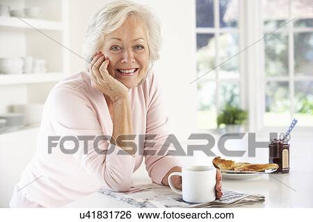 Retired woman eating breakfast View Large Photo Image Stock Photograph - Retired woman eating breakfast. Fotosearch