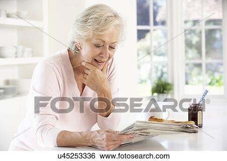 Retired woman eating breakfast View Large Photo Image Stock Photograph - Retired woman eating breakfast. Fotosearch