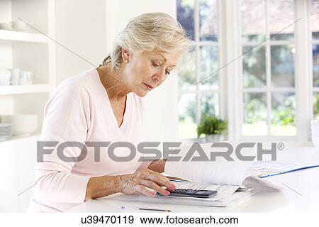 Retired woman with household bills View Large Photo Image Stock Photo - Retired woman with household bills. Fotosearch