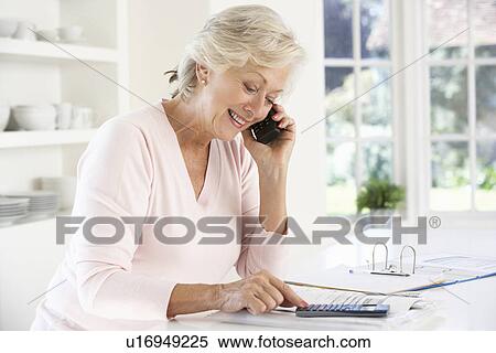 Retired woman with household bills View Large Photo Image Stock Photography - Retired woman with household bills. Fotosearch