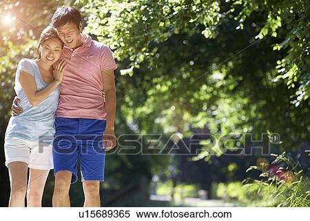 Stock Photography - Romantic Asian Couple On Walk In Countryside. Fotosearch
