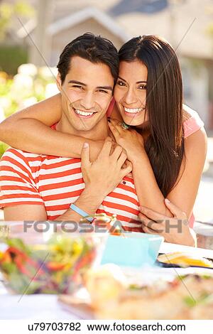 Stock Image - Romantic Couple Enjoying Outdoor Meal In Garden. Fotosearch