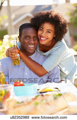 Romantic Couple Enjoying Outdoor Meal In Garden View Large Photo Image Stock Photo - Romantic Couple Enjoying Outdoor Meal In Garden. Fotosearch