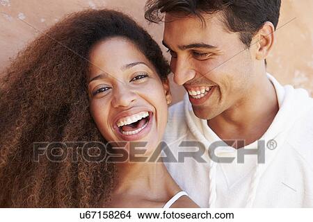 Picture - Romantic Couple On Holiday Together Posing By Wall. Fotosearch