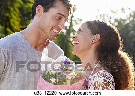 Romantic Man Giving Woman Bunch Of Flowers View Large Photo Image Stock Image - Romantic Man Giving Woman Bunch Of Flowers. Fotosearch