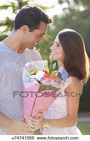 Romantic Man Giving Woman Bunch Of Flowers View Large Photo Image Stock Photo - Romantic Man Giving Woman Bunch Of Flowers. Fotosearch