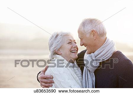 Stock Image - Romantic Senior Couple On Winter Beach. Fotosearch