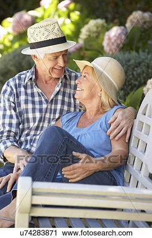 Romantic senior couple relaxing in garden View Large Photo Image Stock Image - Romantic senior couple relaxing in garden. Fotosearch